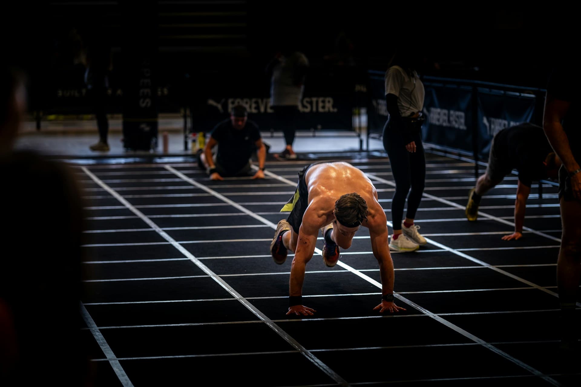 Athletes lined up on the track during a heat-based fitness race